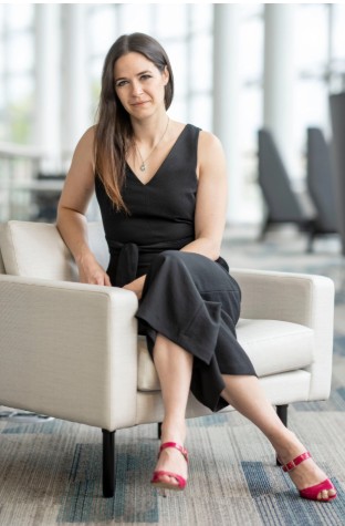 Erin in chair red shoes.jpg